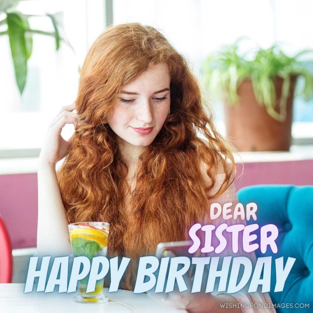 Smiling cute girl is resting in cafe by window, holding smartphone in her hand. Happy Birthday Siste